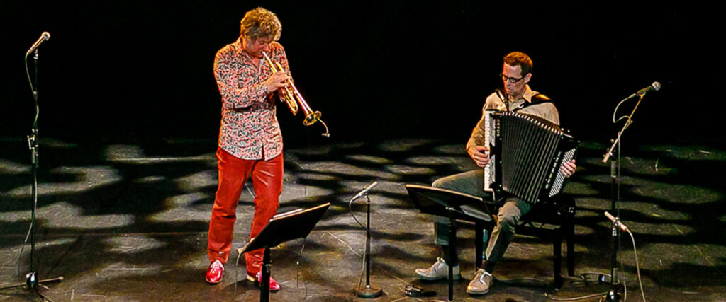 Eric Vloeimans and Will Holshouser playing on a stage.